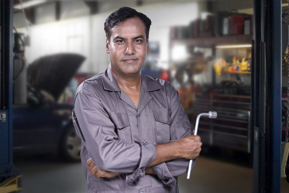Experienced automotive professional inspecting tires